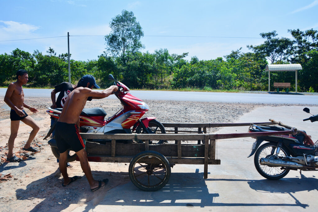 People giving lift to a scooter