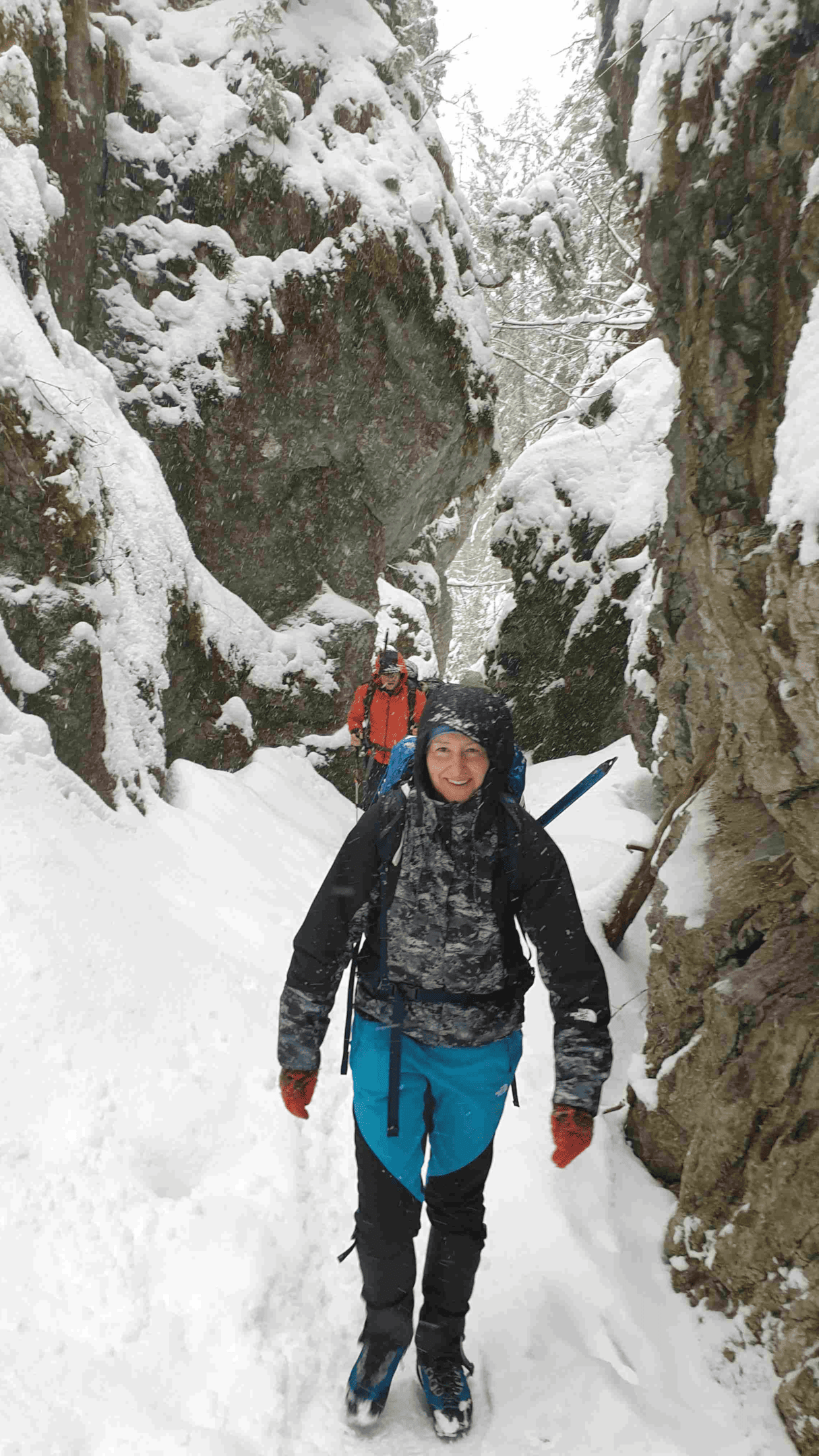 female traveller walking through an iced mountain